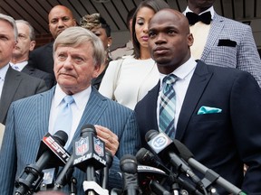 Defense attorney Rusty Hardin, (L) and NFL running back Adrian Peterson of the of the Minnesota Vikings address the media after Peterson plead "no contest" to a lesser misdemeanor charge of reckless assault on November 4, 2014 in Conroe, Texas. (Bob Levey/Getty Images/AFP)