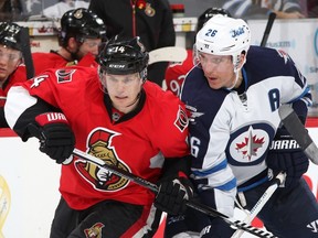 Colin Greening of the Ottawa Senators battles for position against Blake Wheeler #26 of the Winnipeg Jets in the third period during an NHL game at Canadian Tire Centre on November 8, 2014 in Ottawa, Ontario, Canada. (Jana Chytilova/Freestyle Photography/Getty Images/AFP)