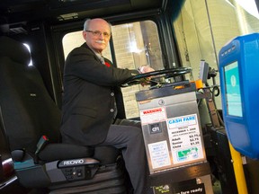 London Transit Commission general manager Larry Ducharme sits at the wheel of a bus, surrounded by technological advances introduced under his watch, at the company's Highbury Avenue headquarters in London.  Ducharme has announced he is retiring. (CRAIG GLOVER, The London Free Press)