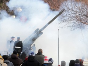 Winnipeggers look on as one of three guns fires a blank round during a Remembrance Day  Ceremony in Winnipeg, at the Legislative Building.  Tuesday, November 11, 2014.  Chris Procaylo/Winnipeg Sun/QMI Agency