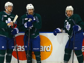 Linemates Peter Holland (left), Mike Santorelli and Leo Komarov take a break during Maple Leafs practice at the MasterCard Centre on Tuesday. (Dave Abel/Toronto Sun)