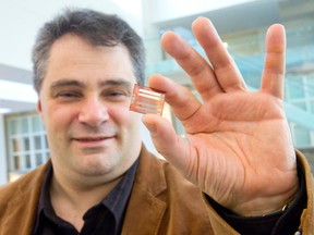 Prof. Giovanni Fanchini holds a solar cell containing gold nanoclusters, which can increase the cell?s performance by more than 10%, at Western University?s Department of Physics and Astronomy in London Tuesday. (CRAIG GLOVER, The London Free Press)