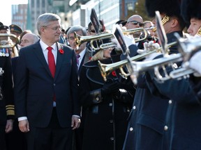Prime Minister Stephen Harper watches the drive past at the Remembrance Day ceremony at the National War Memorial in Ottawa on Tuesday, Nov. 11,  2014. Thousands of people gathered at the National War Memorial to take part in the National Remembrance Day Ceremony. Tony Caldwell/Ottawa Sun/QMI Agency