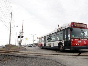 A OC Transpo bus crosses the tracks on Fallowfield Drive in Ottawa On. Tuesday, April 29,  2014.  Tony Caldwell/Ottawa Sun/QMI Agency