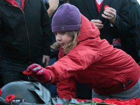 People lay poppies on the tomb of the unknown soldier at the National War Memorial to mark Canada's observance of Remembrance Day in Ottawa on Tuesday Nov 11,  2014.  Tony Caldwell/Ottawa Sun/QMI Agency