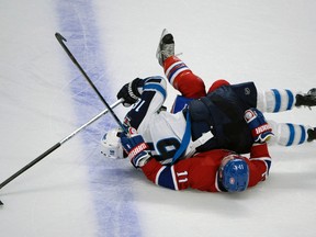 Nov 11, 2014; Montreal, Quebec, CAN; Winnipeg Jets forward Andrew Ladd (16) gets tangled up with Montreal Canadiens forward Brendan Gallagher (11) during the second period at the Bell Centre. Mandatory Credit: Eric Bolte-USA TODAY Sports
