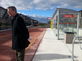 Mayor Jim Watson waits to speak at the opening of bus lanes and a station in the median of Chapman Mills Dr. in Barrhaven on Wednesday, Nov. 12, 2014. JON WILLING/OTTAWA SUN