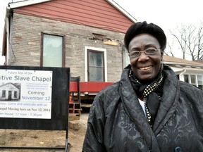 Rev. Delta McNeish, also a member of the Fugitive Slave Chapel Preservation Project, stands next to The Fugitive Slave Chapel at it’s new location on Grey Street Nov. 12, 2014. CHRIS MONTANINI\LONDONER\QMI AGENCY
