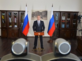 Russian President Vladimir Putin takes part in a video conference, November 12, 2014. REUTERS/Alexei Druzhinin/RIA Novosti/Kremlin
