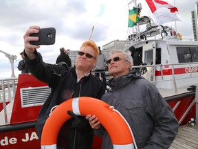Col. Amadeu Fonseca, left, of the Rio de Janeiro Fire Department takes a selfie photo with Bob Clark of MetalCraft Marine in front of a fireboat the Brazillians recently purchased at Flora MacDonald Confederation Basin on Wednesday.  (Ian MacAlpine/The Whig-Standard)