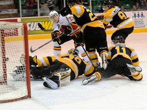Belleville Bulls' David Tomasek scores on a prone Lucas Peressini of the Kingston Frontenacs during Ontario Hockey League action at the Yardmen Arena in Belleville on Wednesday night. (Don Carr Photography)