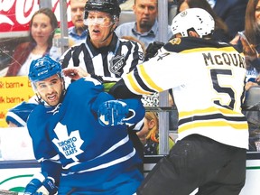 Bruins’ Adam McQuaid drills Leafs’ Nazem Kadri on Wednesday night. McQuaid later challenged Daniel Winnik to a fight. (Craig Robertson/Toronto Sun)