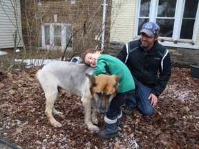 JOHN LAPPA/THE SUDBURY STAR
In this file photo, William Haskett, 4, hugs the family dog, Partner, as William's dad, Neil, looks on outside the family home.