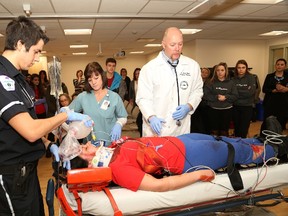 JOHN LAPPA/THE SUDBURY STAR
Dr. Jason Prpic, right, registered nurse Theresa Murray and College Boreal paramedic student Jonathan Rossi take part in a simulated trauma demonstration in front of St. Charles College students for the Prevent Alcohol and Risk-Related Trauma in Youth (P.A.R.T.Y.) program at Health Sciences North on Wednesday. The program, which educates students about the serious consequences of risky behaviour and poor decisions, received $5,000 in funding from the Sudbury Credit Union and the Greater Sudbury Police Service.