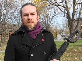 Rob Houde is pictured with an umbrella police questioned him about at Tuesday's Remembrance Day parade. Houde says he's concerned about the level of weaponry that was present at this year's event. TYLER KULA/ THE OBSERVER/ QMI AGENCY