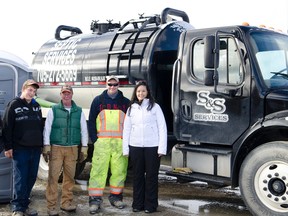 The S&S Environmental Services staff pose outside of their current shop.