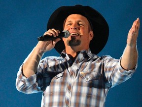 Country music star Garth Brooks performs at the 48th ACM Awards in Las Vegas in this file photo taken April 7, 2013. Brooks said on Thursday he was coming out of retirement and will release new music for the first time in more than decade. REUTERS/Mario Anzuoni/Files