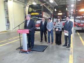Local MPPs and city officials were at the OC Transpo garage on Industrial Ave. Thursday to announce the city will receive $33.7 million in gas tax in 2014. (JON WILLING Ottawa Sun)