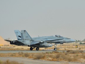 A Royal Canadian Armed Forces CF-18 Hornet fighter jet from 4 Wing Cold Lake, Alberta lands in Kuwait after the first combat mission over Iraq in support of Operation IMPACT on October 30, 2014. Photo: Canadian Forces Combat Camera, DND