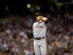 Barry Zito #75 of the San Francisco Giants rubs his neck between pitches during a tough outing against the Colorado Rockies at Coors Field on August 26, 2013 in Denver, Colorado. (Dustin Bradford/Getty Images/AFP)