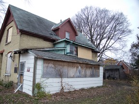This vacant, boarded-up house at 876 Van St. (DEREK RUTTAN, The London Free Press)