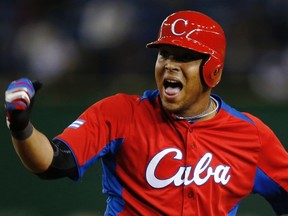 Cuba's Yasmany Tomas reacts after hitting an RBI single against the Netherlands in the eighth inning at the World Baseball Classic (WBC) second round game in Tokyo March 11, 2013. (REUTERS/Toru Hanai)
