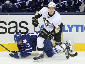 Pittsburgh Penguins defenseman Olli Maatta (3) looks on as Toronto Maple Leafs left wing Joffrey Lupul (19) falls at the Air Canada Centre on Oct 11, 2014 in Toronto, Ontario, CAN. (Tom Szczerbowski/USA TODAY Sports)