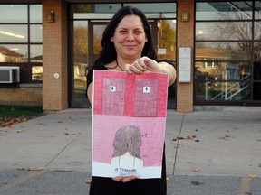 Central Elgin Collegiate Institute teacher Lorianne Girard stands outside the school, holding a poster a student designed for the Transgender Week of Awareness. CECI is observing the week from Nov. 11-17 as a way of educating people about transgender issues and promoting acceptance. (Ben Forrest, Times-Journal)
