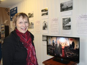 Christine Sypnowich, president of the Barriefield Village Association, stands in front of a new exhibition at the Marine Museum of the Great Lakes that celebrates Barriefield's once-thriving boatbuilding industry. (Michael Lea/The Whig-Standard)
