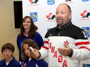 Former National Hockey League player Wendel Clark, middle, was  in Kingston on Thursday to promote two coming World Junior pre-competition games in Kingston on Dec 21 and 23. With him are children taking part in a Learn to skate program, from left, Dylan Vandusen, 9, and Cassey Stretch, 9 with Cynthia Crampton of RBC (Ian MacAlpine/The Whig-Standard)