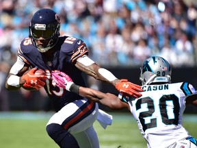 Chicago Bears wide receiver Brandon Marshall (15) tries to elude Carolina Panthers cornerback Antoine Cason during NFL action at Bank of America Stadium. (Bob Donnan/USA TODAY Sports)