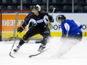 London Knights forward Christian Dvorak, right, is challenged by Knights defenceman Chris Martenet during a team hockey practice at Budweiser Gardens in London on Wednesday November 12, 2014. (CRAIG GLOVER, The London Free Press)