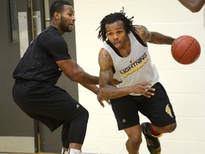 Guard Stephen McDowell drives on London Lightning teammate Kurt Alexander during practice at the Central YMCA on Thursday. The Lightning play the Island Storm on Saturday at Budweiser Gardens. (MORRIS LAMONT, The London Free Press)