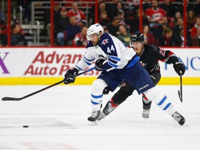 Winnipeg Jets defensemen Zach Bogosian (44) skates with puck against the Carolina Hurricanes forward Riley Nash (20) during the 3rd period at PNC Arena. The Winnipeg Jets  defeated the Carolina Hurricanes 3-1. Mandatory Credit: James Guillory-USA TODAY Sports