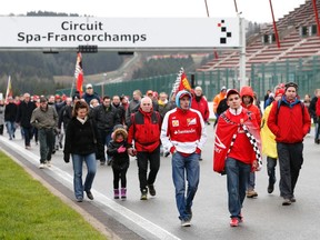 Ferrari fans walk during a tribute to seven-times former Formula One world champion Michael Schumacher at the Circuit of Spa-Francorchamps January 26, 2014. (REUTERS/Francois Lenoir)