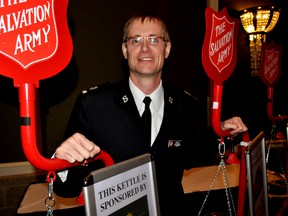 Perron Goodyear, public relations and development representative for The Salvation Army, Ontario Great Lakes Division, stands next to a row of Christmas kettles following The Salvation Army’s annual Hope in the City Breakfast in London Ont. Nov. 14, 2014. CHRIS MONTANINI\LONDONER\QMI AGENCY