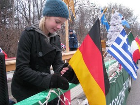 Ashleigh Kilner is shown in this file photo adjusting a flag on the 32nd Scouting group float before the start of the 2011 Sarnia Kinsmen Christmas Parade of Lights. This year's parade is set for Dec. 6, beginning at 6 p.m. Entries are still being accepted. FILE PHOTO/THE OBSERVER/QMI AGENCY