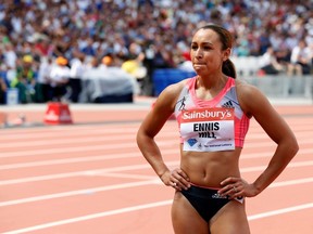 Jessica Ennis-Hill of Great Britain watches the replay after taking fourth place in the women's 100m hurdles event at the London Diamond League 'Anniversary Games' athletics meeting in east London July 27, 2013. (REUTERS/Suzanne Plunkett)