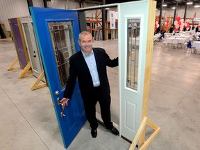 George Warren, president of Centennial Windows, opens the door Friday to continued sales growth in the firm?s new facility, to be used for door manufacturing. (MORRIS  LAMONT, The London Free Press)
