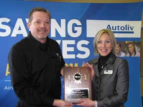 Pete Metcalfe, plant manager of Autoliv in Tilbury, is presented with the Feature Industry of the Month award by Sarah Callow, a director with the Chatham-Kent Chamber of Commerce. The award presentation was held on Nov. 14.
