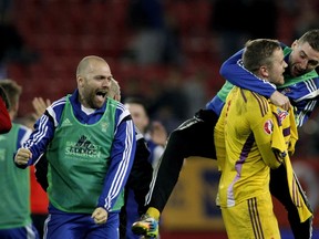 Faroe Island's players celebrate after winning the UEFA Euro 2016 group F qualifying football match between Greece and Faroe Island at the Karaiskaki stadium in Piraeus, near Athens, on November 14, 2014. (AFP PHOTO/ ANGELOS TZORTZINIS)