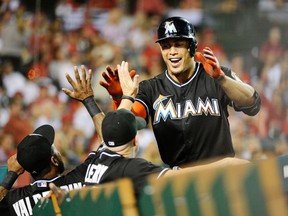 Miami Marlins right fielder Giancarlo Stanton (27) celebrates with teammates after hitting a three-run home run during the fourth inning against the Los Angeles Angels at Angel Stadium of Anaheim on Aug 25, 2014 in Anaheim, CA, USA. (Richard Mackson/USA TODAY Sports)