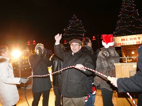 Performing the official lighting are from left, councillors Jackie Denyes. Tom Lafferty, mayor-elect Taso Christopher, Garnet Thompson, Egerton Boyce, light committee member Heather Henderson and mayor Neil Ellis cheering as the display is lit. 
Emily Mountney-Lessard/The Intelligencer/QMI Agency