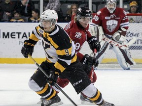 Kingston Frontenacs' Corey Pawley steals the puck from Guelph Storm's Stephen Pierog to keep it in the Storm's end during the first period of Ontario Hockey League action at the Rogers K-Rock Centre on Friday, Nov. 14.