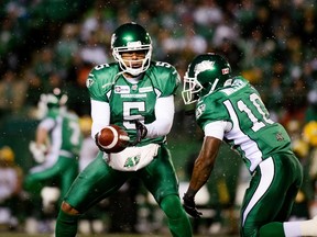 Saskatchewan Roughriders' Kerry Joseph hands the ball off to Steven Miller during the first half of their CFL football game against the Edmonton Eskimos on November 8, 2014. (REUTERS/Matt Smith)