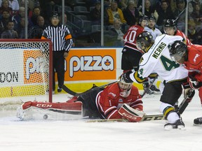 Owen Sound Attack goaltender Jack Flinn makes a pad save on a shot by London Knights defenceman Dakota Mermis as Attack forward Jaden Lindo moves in to recover the rebound during their Ontario Hockey League game at Budweiser Gardens on Friday. (CRAIG GLOVER, The London Free Press)