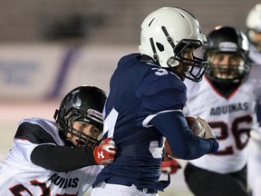 Catholic Central?s Fernando DeLaRosa is tackled by Anthony Fekete of the Aquinas Flames during the London District senior boys football final at TD Stadium on Friday. (CRAIG GLOVER, The London Free Press)