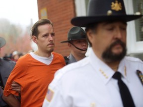 Eric Matthew Frein exits the Pike County Courthouse with police officers after an arraignment in Milford, Pennsylvania, October 31, 2014. A bruised and gaunt Frein, captured after a seven-week manhunt and held with the handcuffs of a Pennsylvania trooper he is accused of slaying, was held without bail on Friday after facing murder charges in court. A massive police presence surrounded the 31-year-old survivalist, who prosecutors say will face the death penalty, as he was escorted in and out of the Pike County Courthouse for a preliminary arraignment on a first-degree murder charge and one count of homicide of a police officer, among other charges.  REUTERS/Mark Makela