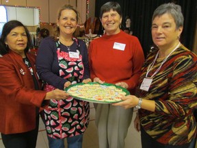 Holding a tray of shortbread cookies that greeted visitors to the IODE Christmas Home Tour in Sarnia Saturday are, from left, co-chairperson Linda Gryner, volunteer Pamela Cunningham, volunteer Astrid Vanderburgt, and co-chairperson Helen Danby. The home tour continues Sunday, 11 a.m. to 4 p.m. Tickets are available beginning at noon at All Saints Anglican Church on Vidal Street in Sarnia. PAUL MORDEN/THE OBSERVER/QMI AGENCY