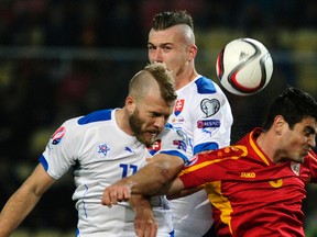 Vance Sikov (right) of Macedonia challenges Adam Nemec and Juraj Kucka (middle) of Slovakia during their Euro 2016 qualifying soccer match in Skopje November 15, 2014. Slovakia won 2-0. (REUTERS/Ognen Teofilovski)